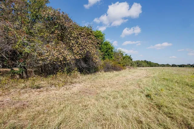 a view of an ocean beach and a yard