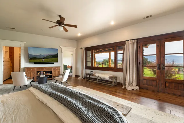 a bedroom with furniture and a flat screen tv