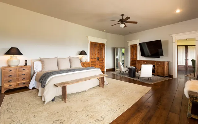 a bedroom with a bed and a flat screen tv