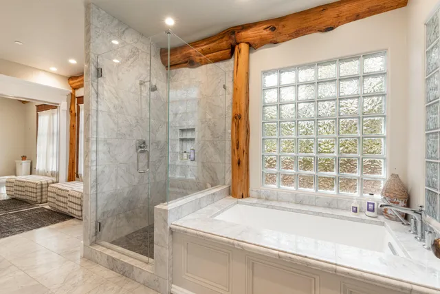 a bathroom with a granite countertop sink and shower