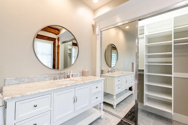 a bathroom with a double vanity sink and a mirror