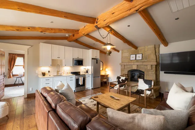 a living room with fireplace furniture and a flat screen tv
