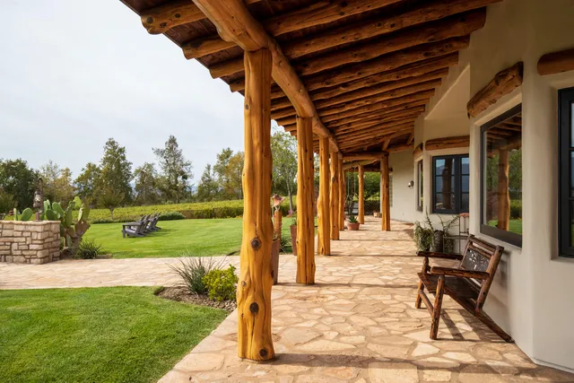 a view of a porch with furniture and garden