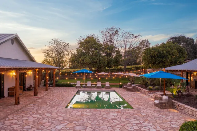 a backyard of a house with yard and outdoor seating