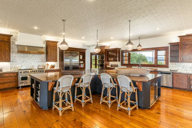 a large kitchen with lots of counter space and stainless steel appliances