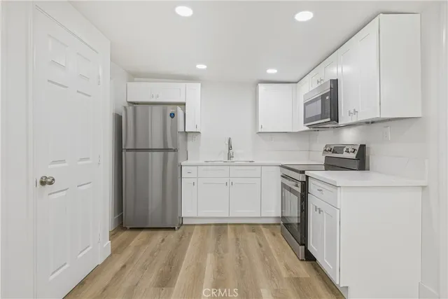 a kitchen with a refrigerator a sink and dishwasher