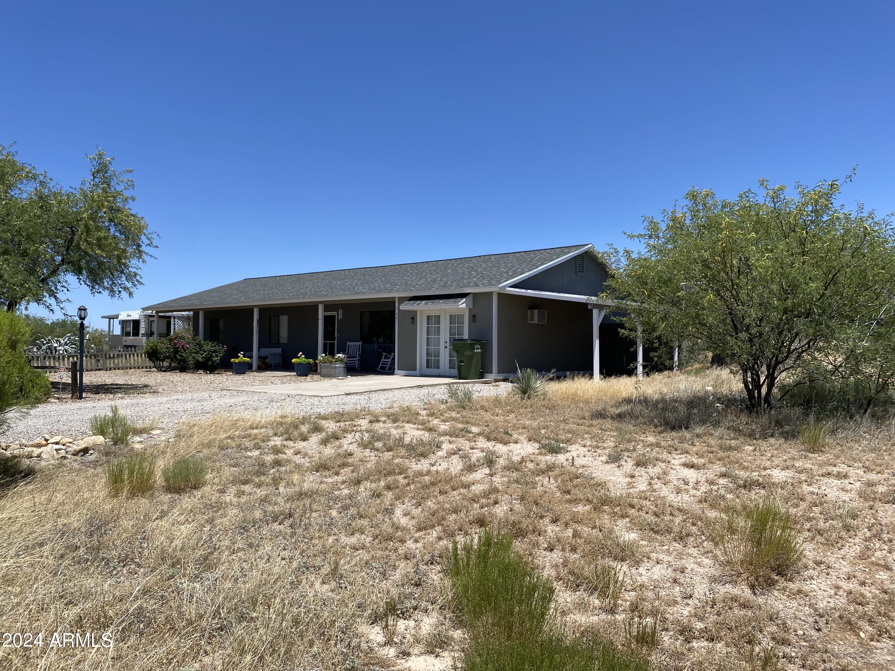 Lot 363 North Mescal Road, Unit 363 Benson, AZ 85602 - Photo 8 of 31 a front view of house with yard and green space