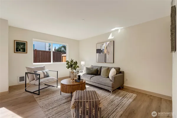 a living room with furniture a rug and a window