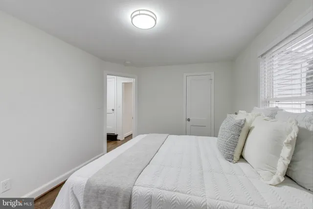 a bedroom with a bed and a window