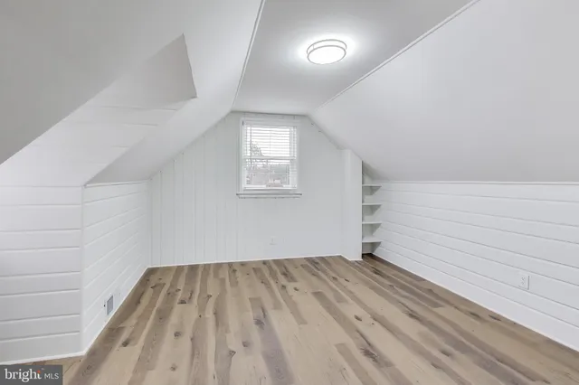 a view of room with window and hardwood floor