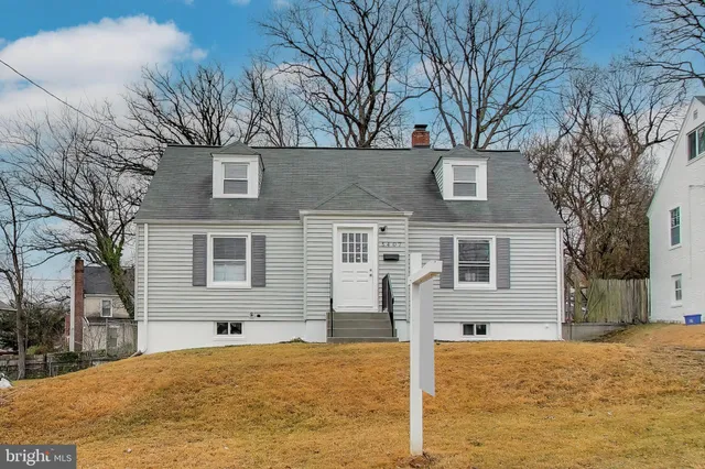a house that has a tree in front of it