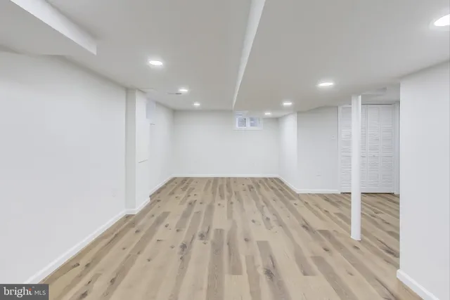 a view of a room with wooden floor and white walls