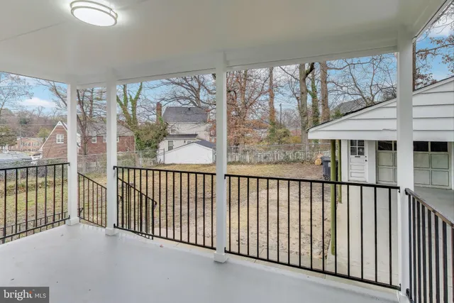 a view of a porch with wooden floor and fence