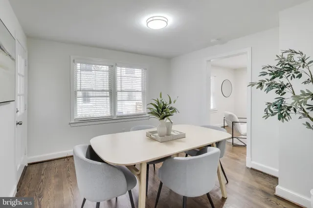a dining room with furniture and wooden floor