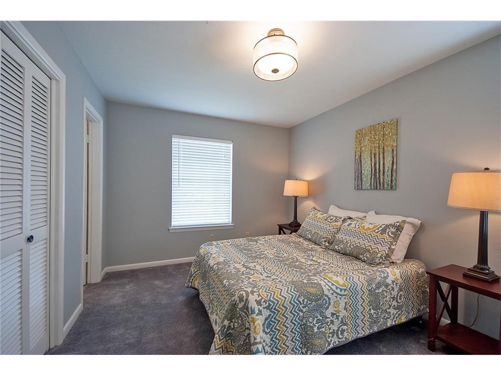8717 Hackney Lane Dallas, TX 75238 - Photo 14 of 21 Bedroom featuring a closet and dark colored carpet