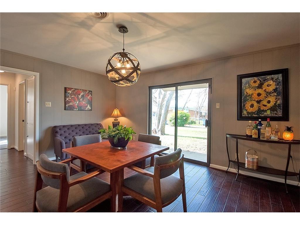 8717 Hackney Lane Dallas, TX 75238 - Photo 8 of 21 Dining area featuring dark wood-style floors and hanging lights
