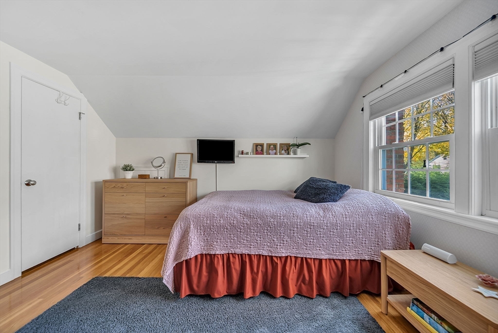 14 Twitchell Street Wellesley, MA 02482 - Photo 19 of 37 a bedroom with a bed and a dresser next to a window