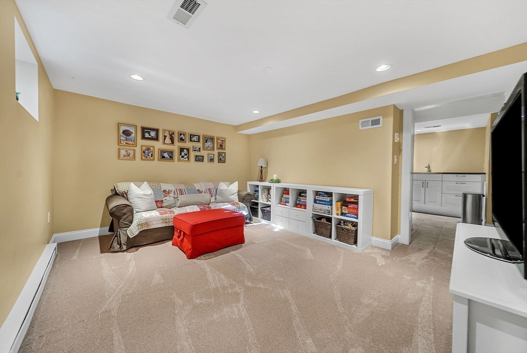 14 Twitchell Street Wellesley, MA 02482 - Photo 25 of 37 a bedroom with furniture and a flat screen tv