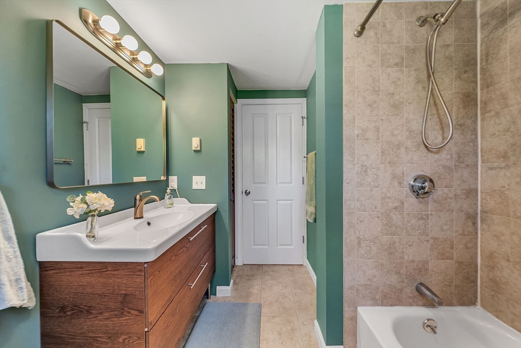 14 Twitchell Street Wellesley, MA 02482 - Photo 32 of 37 a bathroom with a double vanity sink mirror and shower