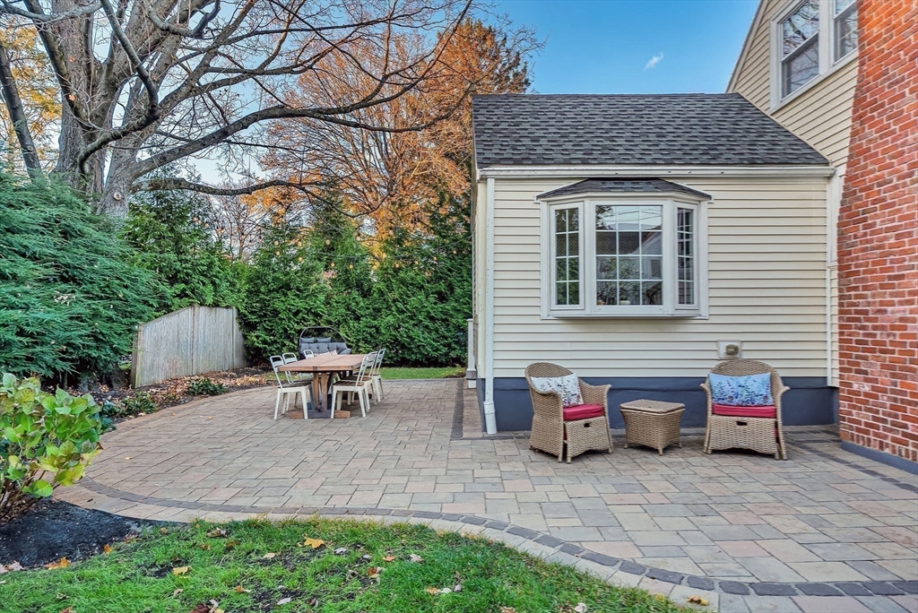 14 Twitchell Street Wellesley, MA 02482 - Photo 35 of 37 a view of a patio with table and chairs with wooden fence