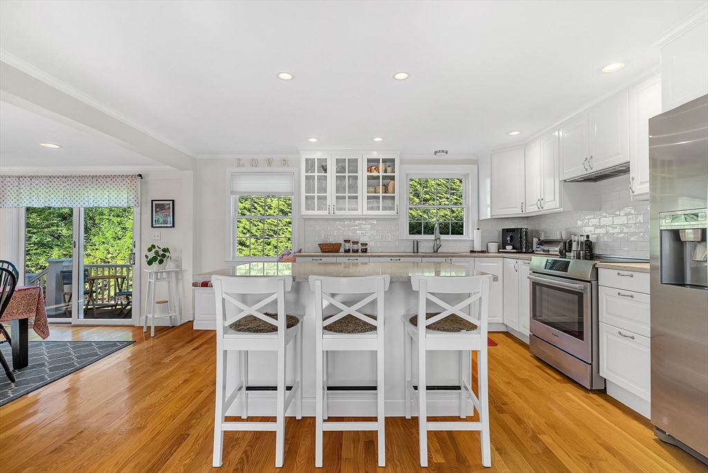 14 Twitchell Street Wellesley, MA 02482 - Photo 4 of 37 a kitchen with a stove a sink a dining table and chairs