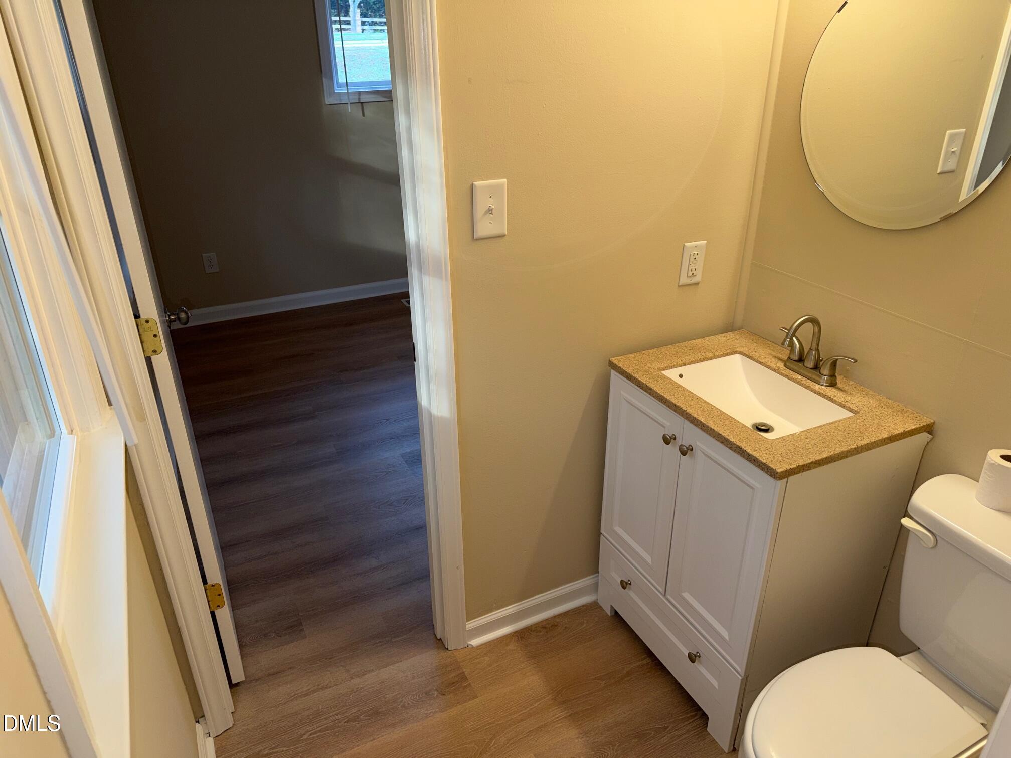 3117 Tryon Road Raleigh, NC 27603 - Photo 13 of 21 a bathroom with a toilet sink and mirror