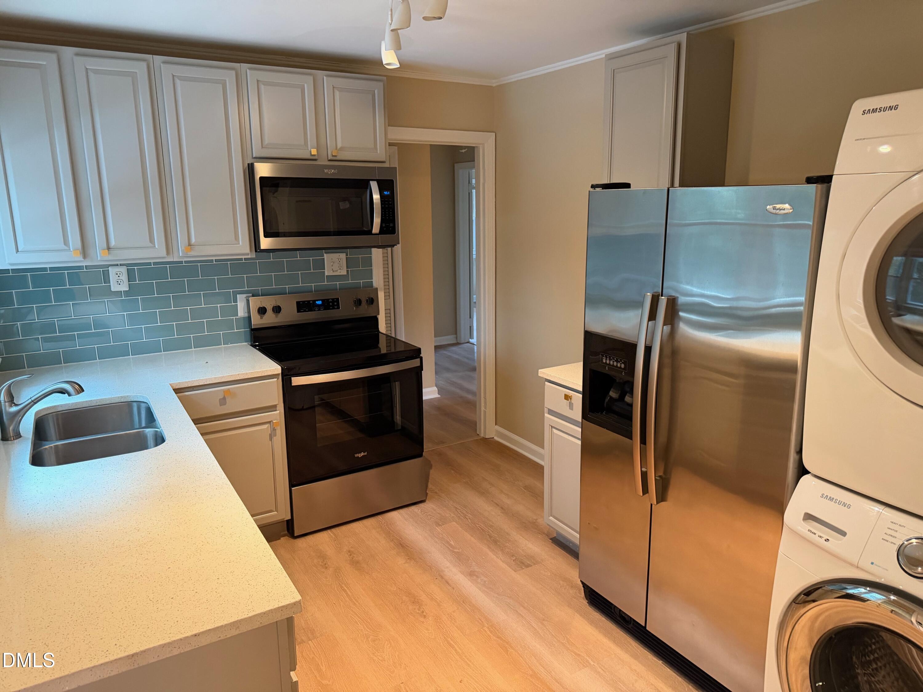 3117 Tryon Road Raleigh, NC 27603 - Photo 15 of 21 a kitchen with a refrigerator sink and stove