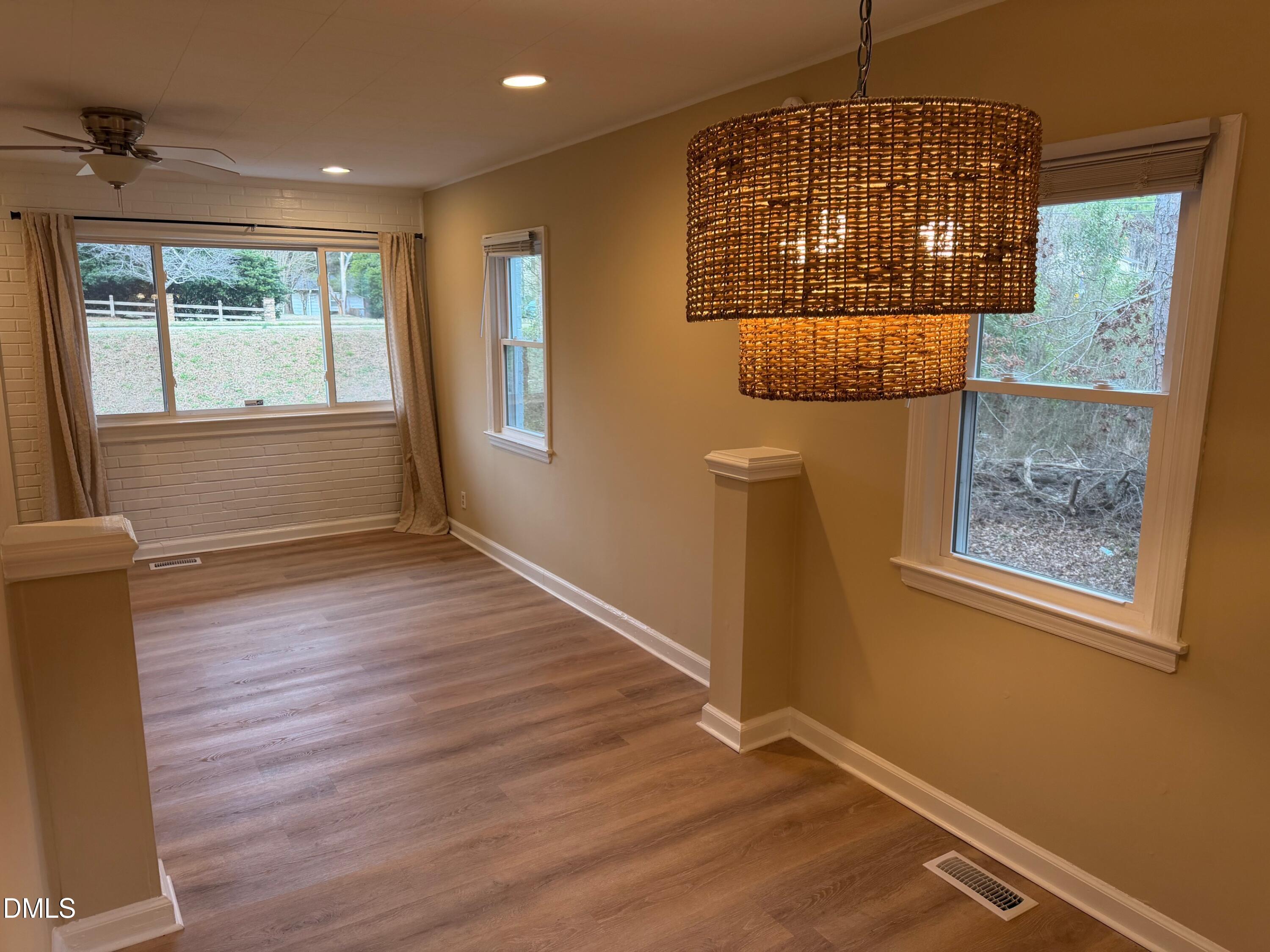3117 Tryon Road Raleigh, NC 27603 - Photo 16 of 21 an empty room with wooden floor and windows