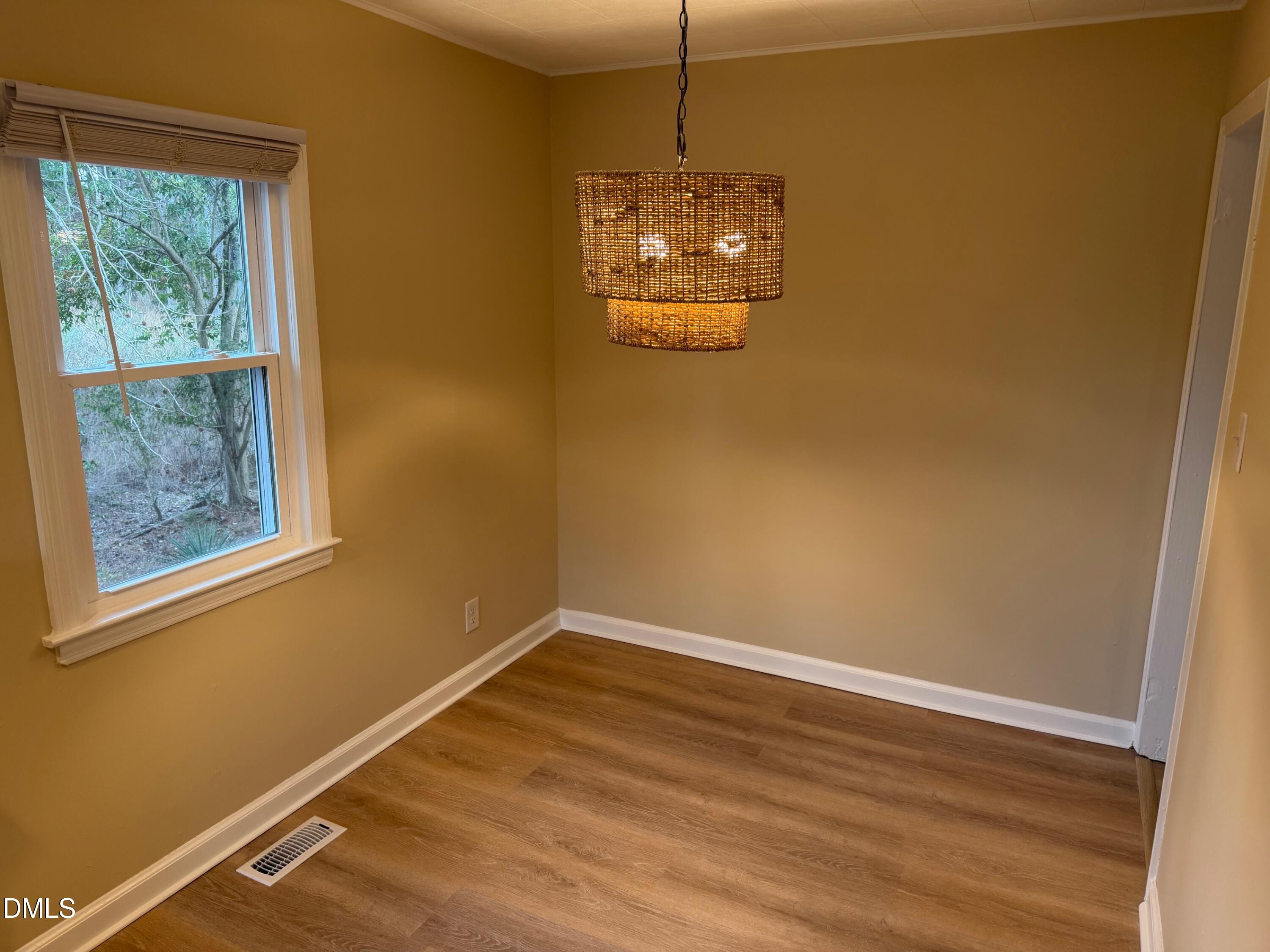 3117 Tryon Road Raleigh, NC 27603 - Photo 17 of 21 a view of a room with a wooden floor and a window