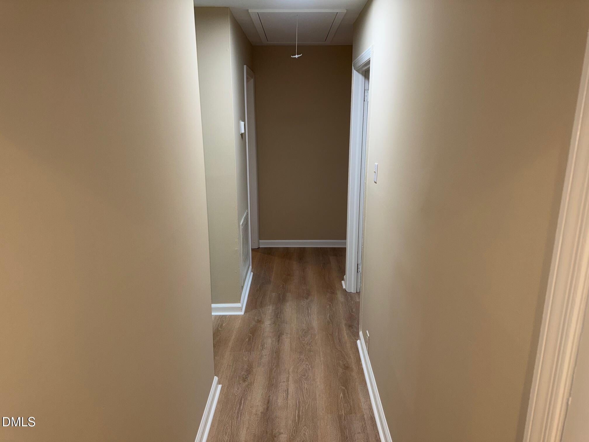 3117 Tryon Road Raleigh, NC 27603 - Photo 18 of 21 a view of a hallway with wooden floor