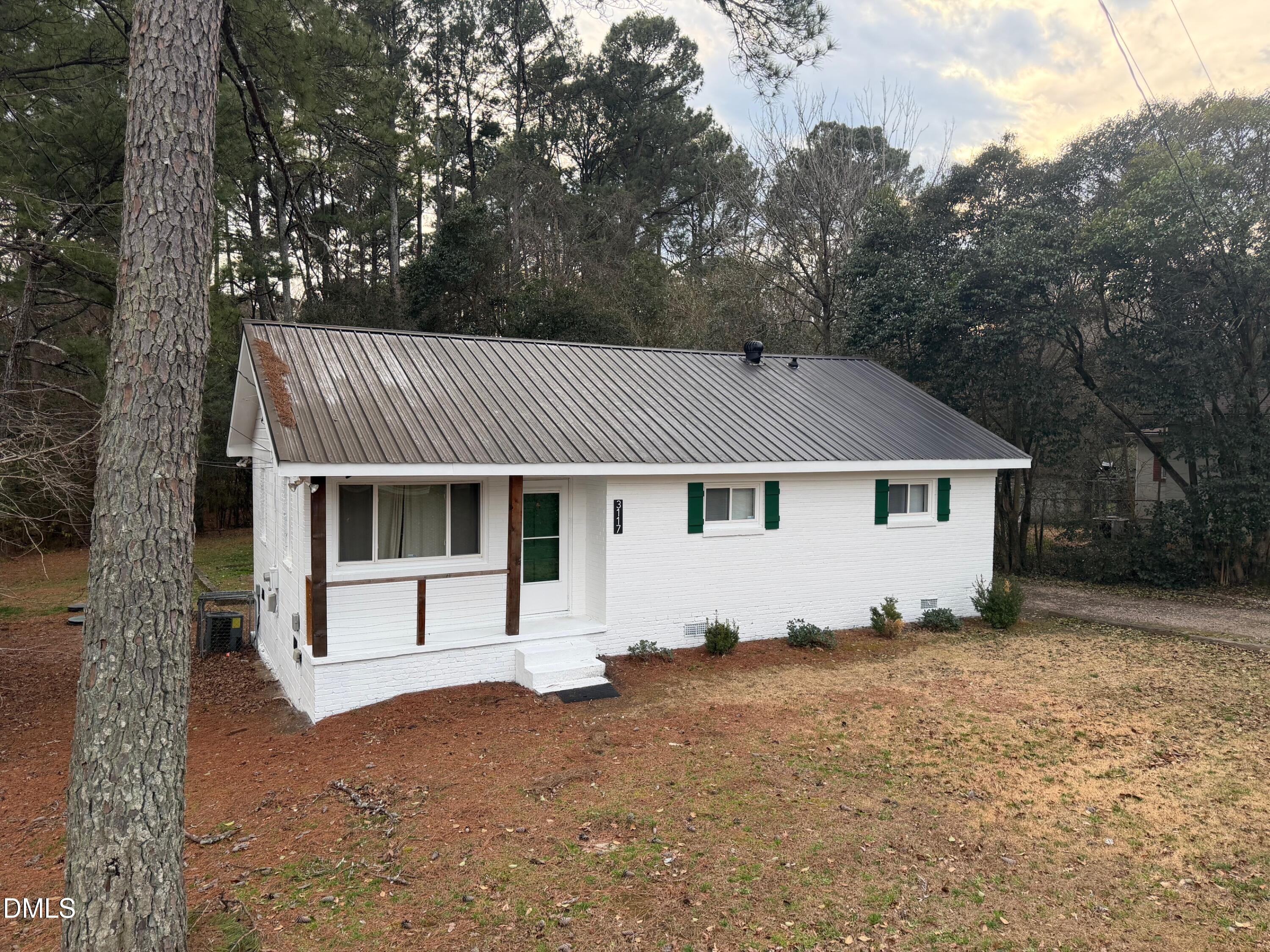 3117 Tryon Road Raleigh, NC 27603 - Photo 2 of 21 a view of a house with a yard and large tree
