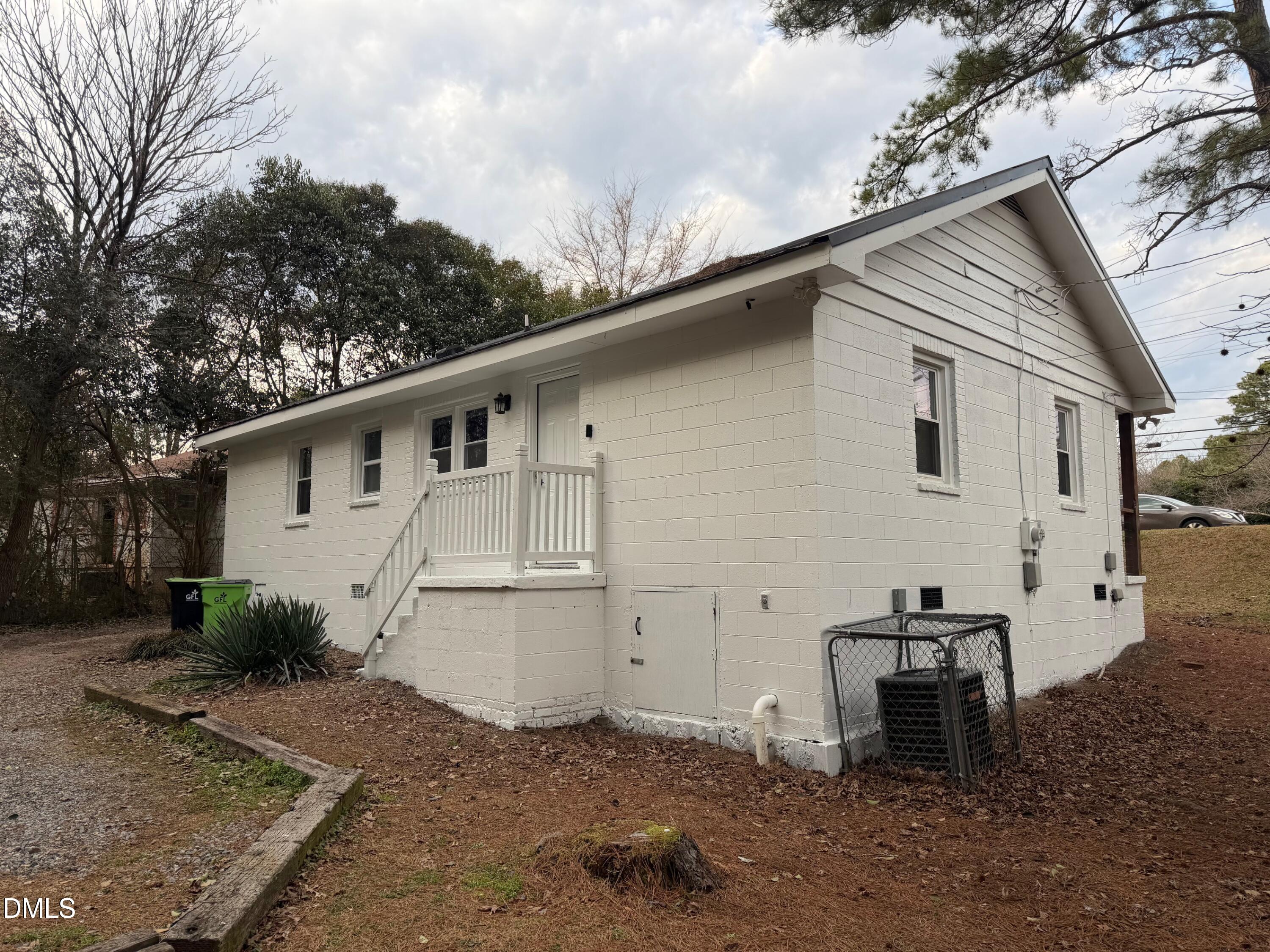 3117 Tryon Road Raleigh, NC 27603 - Photo 5 of 21 a view of a small house with a yard
