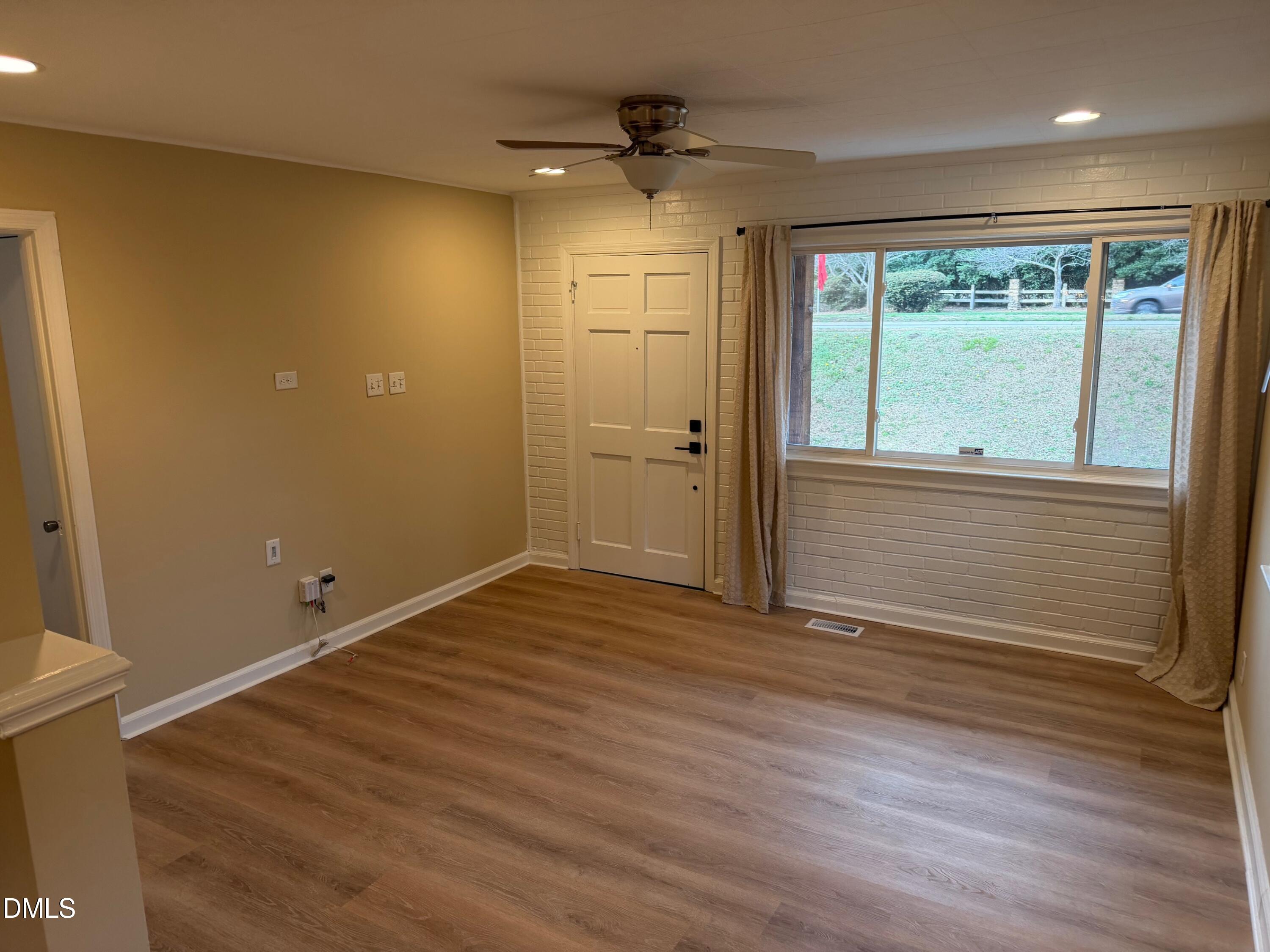 3117 Tryon Road Raleigh, NC 27603 - Photo 7 of 21 a view of an empty room with a window