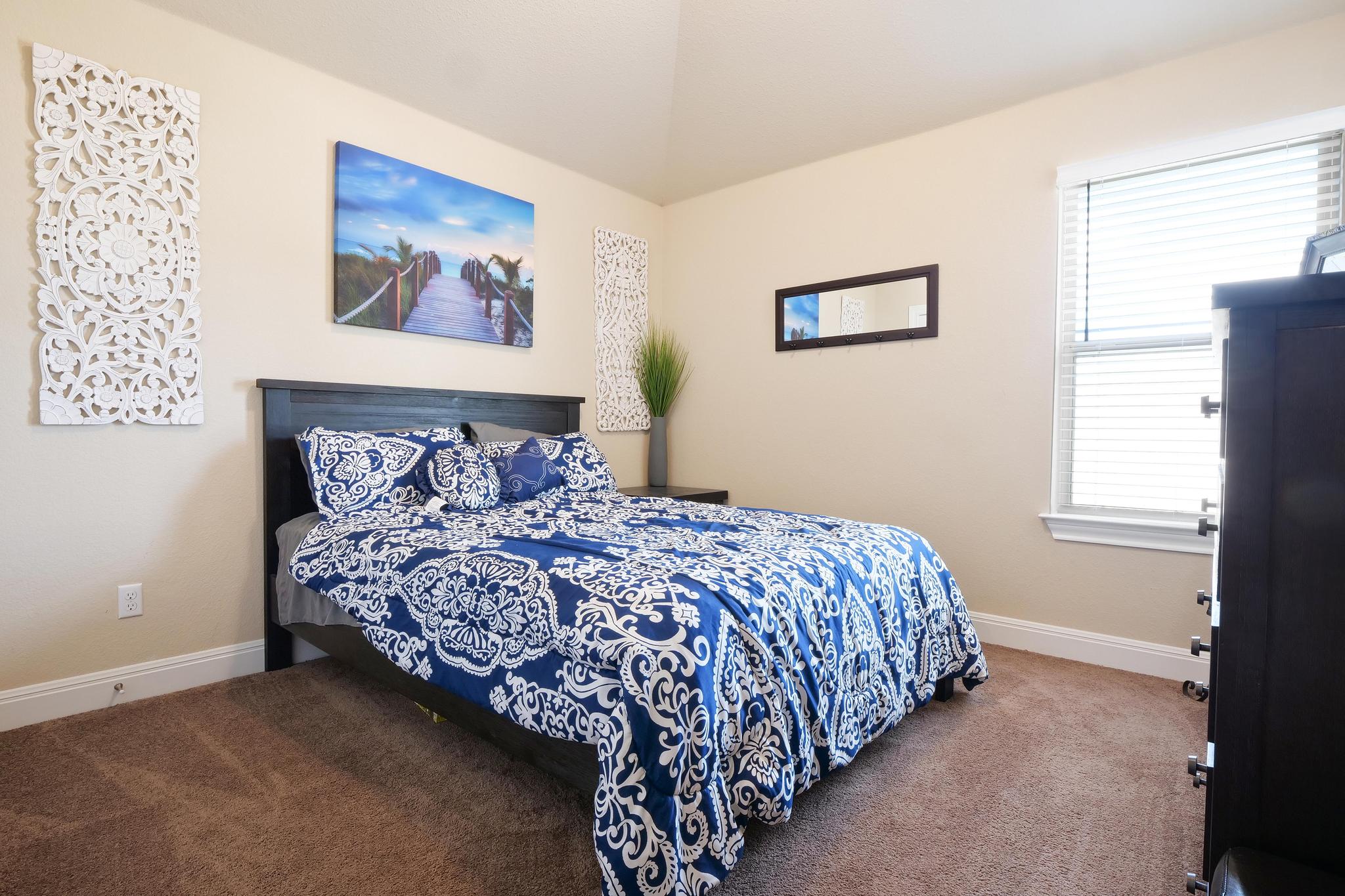 205 Windom Way Georgetown, TX 78626 - Photo 19 of 28 a bed sitting in a bedroom next to a window