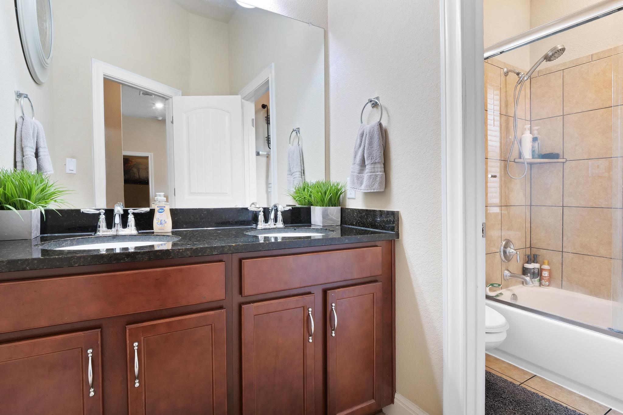205 Windom Way Georgetown, TX 78626 - Photo 21 of 28 a bathroom with a double vanity sink and a mirror