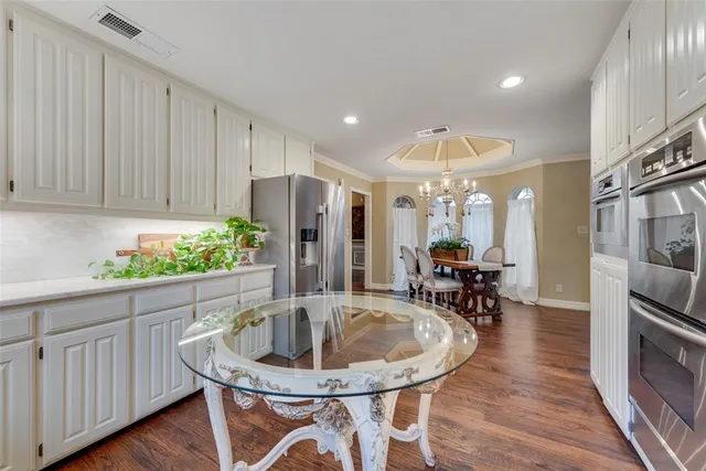 a kitchen with a table and chairs