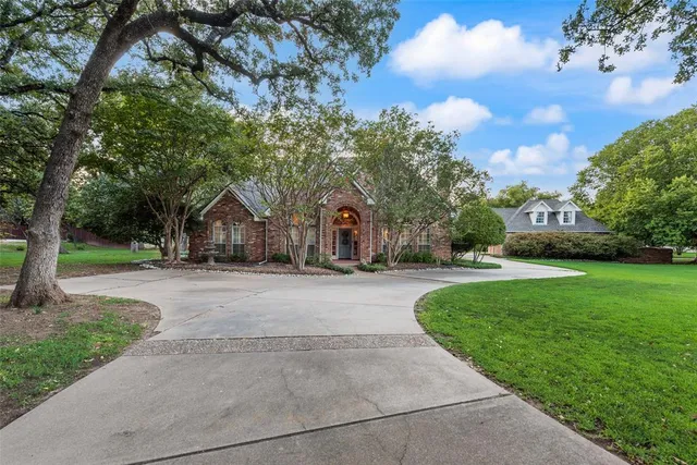 an aerial view of a house with a garden and trees