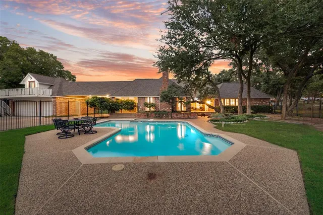 a view of a house with swimming pool and yard