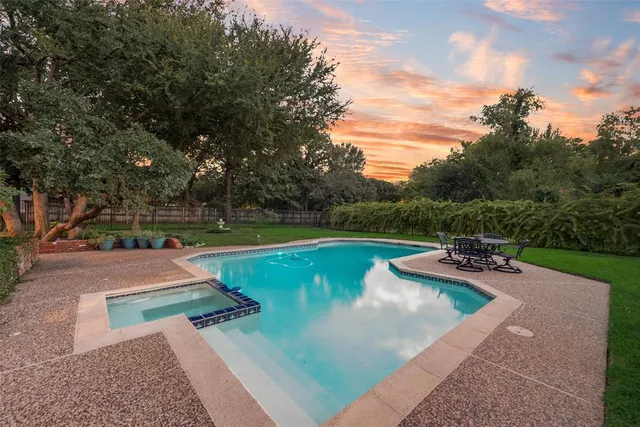 a view of a swimming pool with a yard