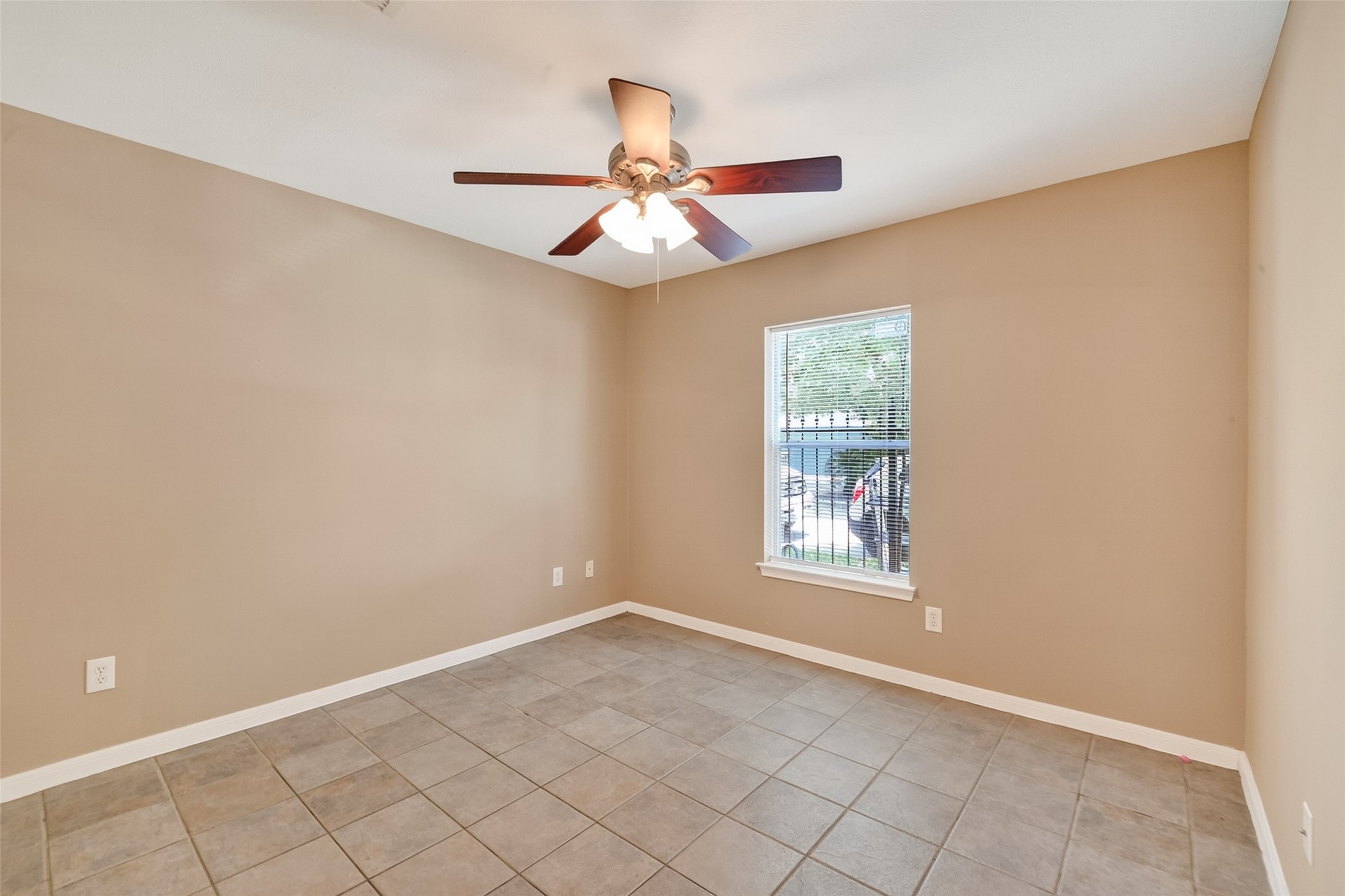 2804 Chenevert Street Houston, TX 77004 - Photo 6 of 37 an empty room with windows and fan