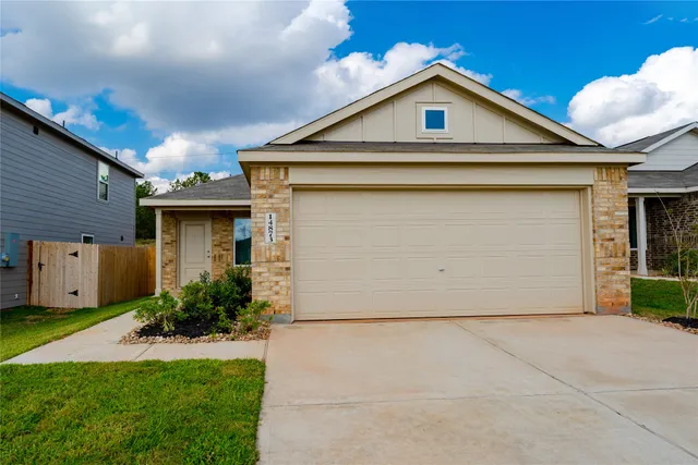 a view of a house with a yard and garage