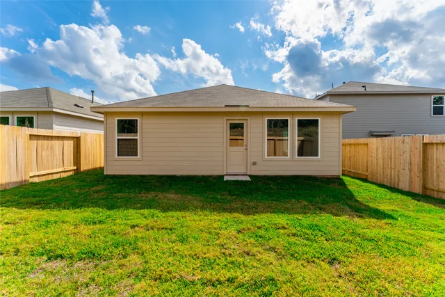 a view of a backyard with plants and a backyard