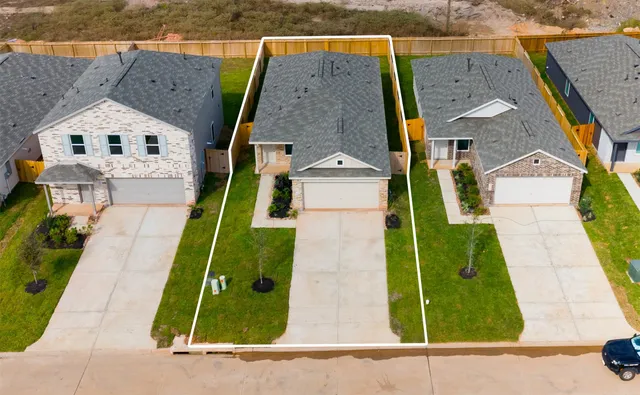 an aerial view of a house with a yard