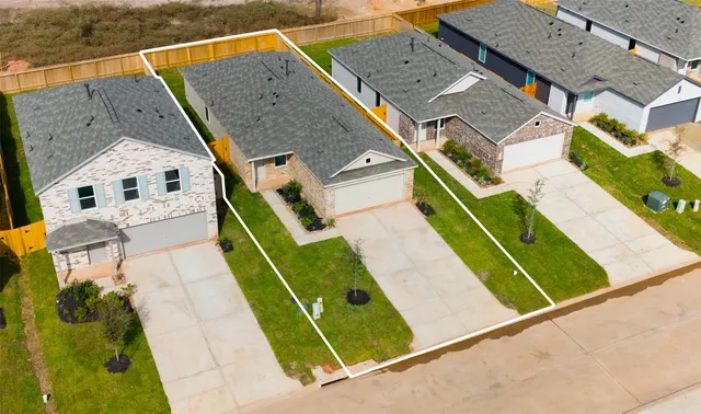 an aerial view of a house with a backyard