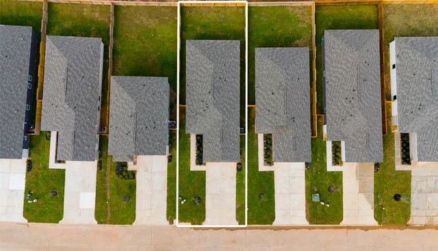 front view of a brick house with a small yard