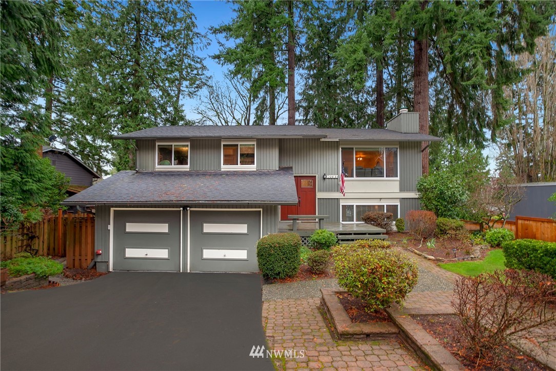 10727 126th Avenue Northeast Kirkland, WA 98033 - Photo 1 of 40 a front view of a house with a garden and trees