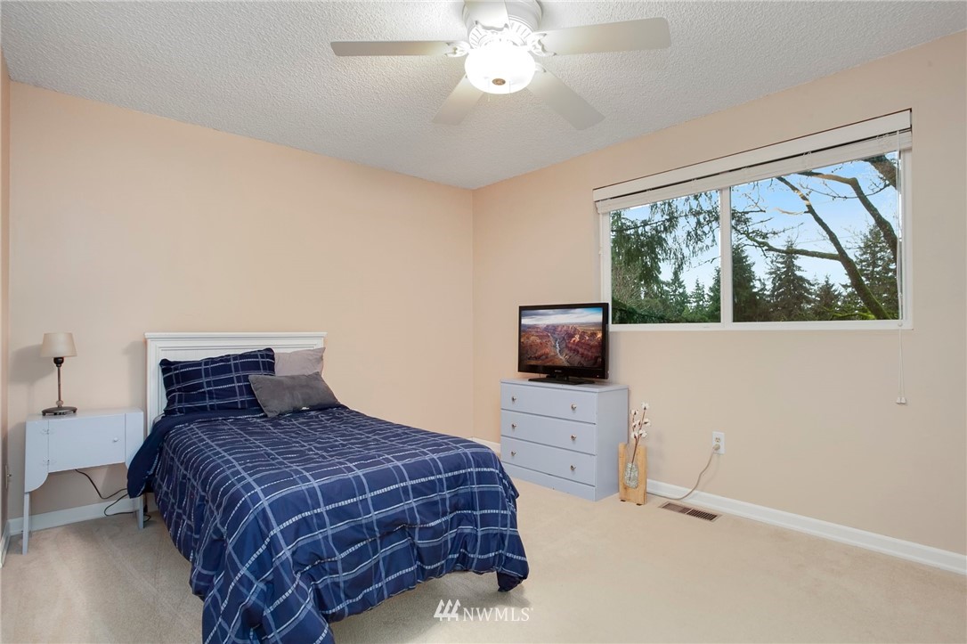 10727 126th Avenue Northeast Kirkland, WA 98033 - Photo 16 of 40 a bedroom with a bed and a flat screen tv