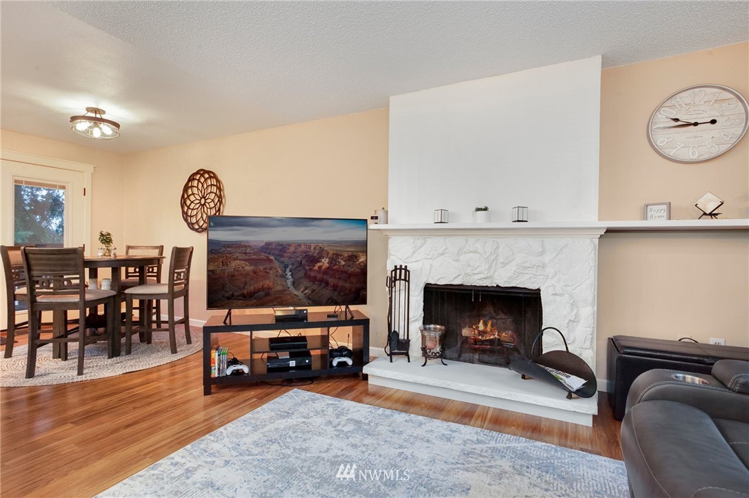 10727 126th Avenue Northeast Kirkland, WA 98033 - Photo 4 of 40 a living room with furniture a fireplace and a flat screen tv