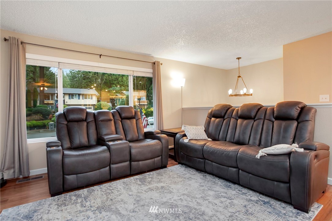 10727 126th Avenue Northeast Kirkland, WA 98033 - Photo 5 of 40 a living room with furniture and a large window