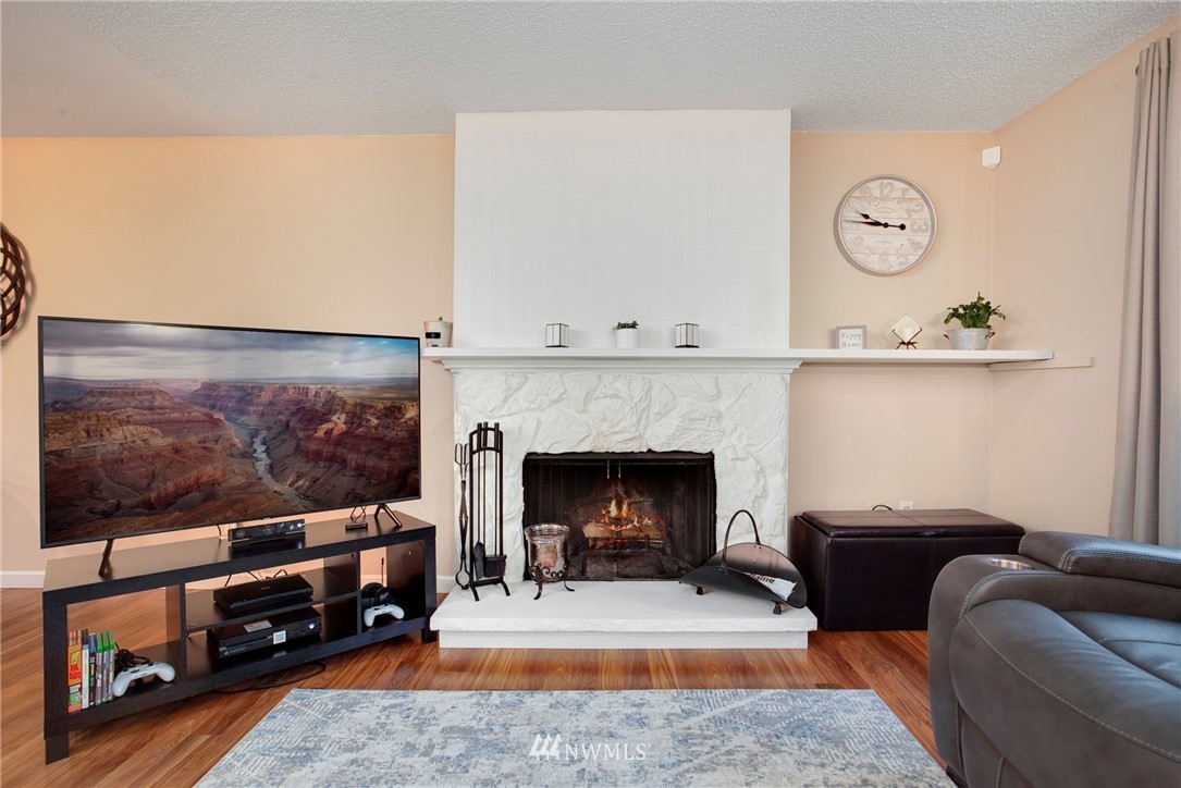 10727 126th Avenue Northeast Kirkland, WA 98033 - Photo 6 of 40 a living room with furniture and a fireplace